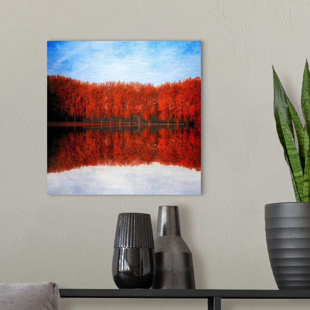 A modern room featuring Reflections of red trees by a lake