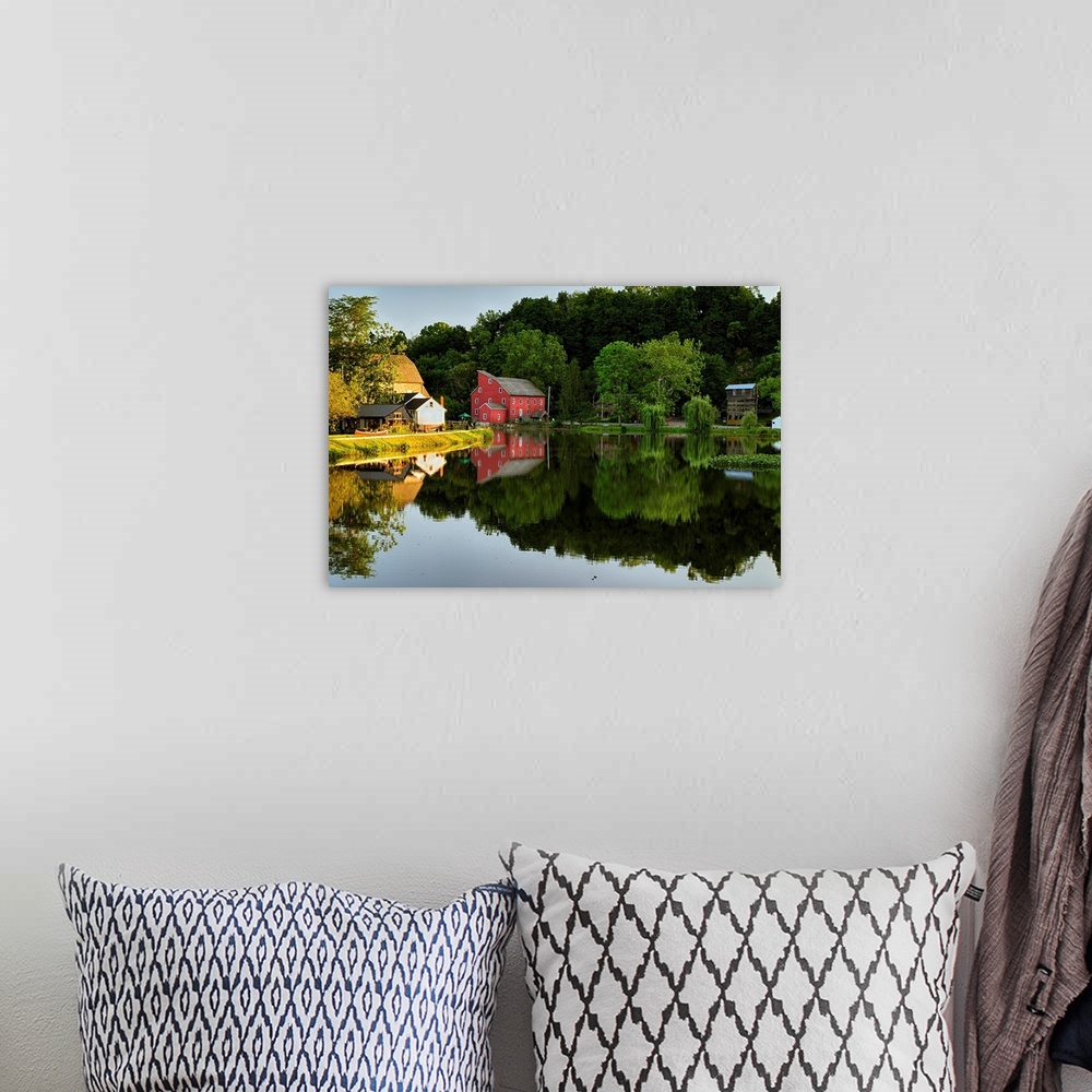 A bohemian room featuring Fine art photo of a bright red house at the edge of a calm lake, with the reflection of the fores...