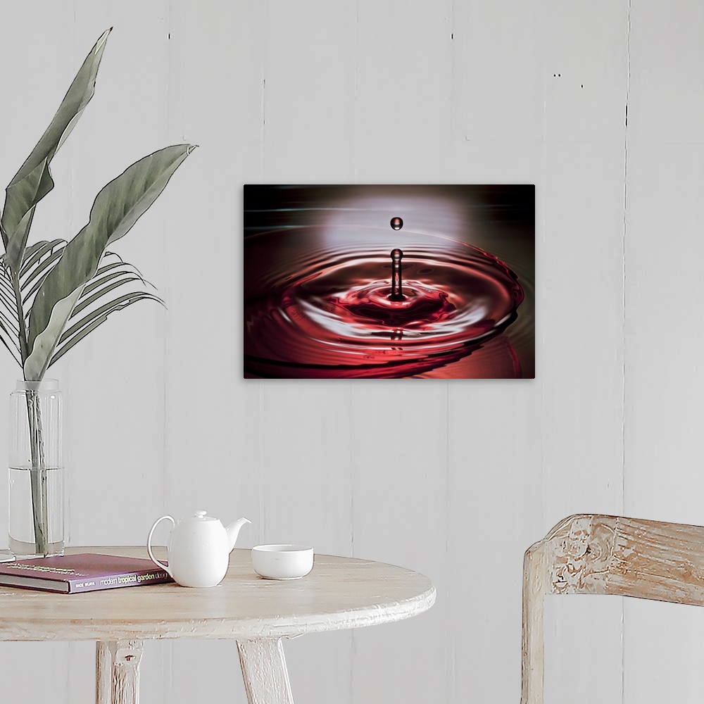 A farmhouse room featuring A macro photograph of a water droplet suspended in air after hitting a watery surface.