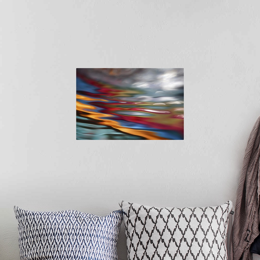 A bohemian room featuring An abstract photograph of vibrant colors in a wave-like formation.