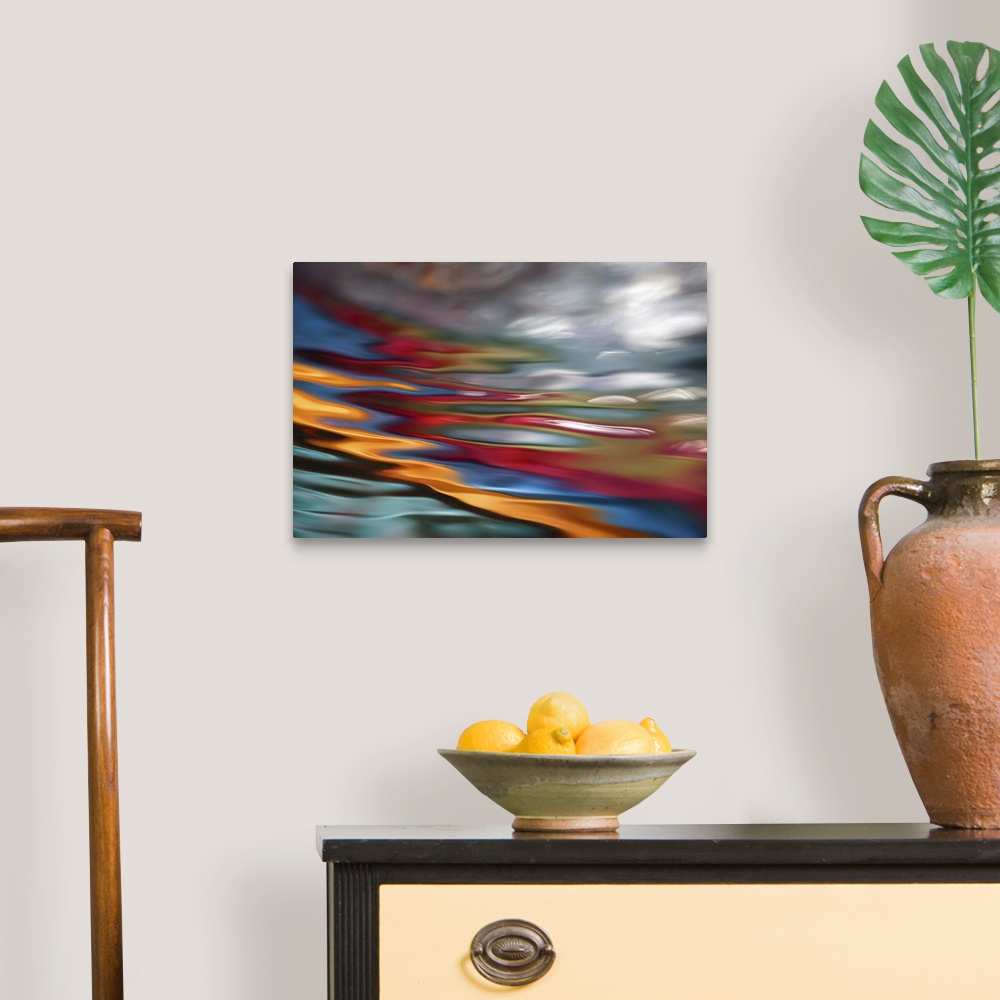 A traditional room featuring An abstract photograph of vibrant colors in a wave-like formation.