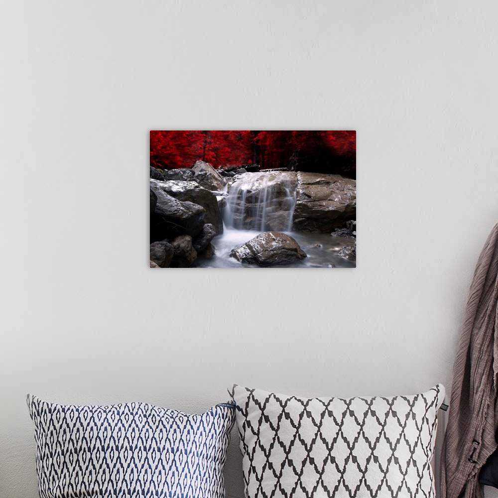 A bohemian room featuring A waterfall in front of a red autumn forest