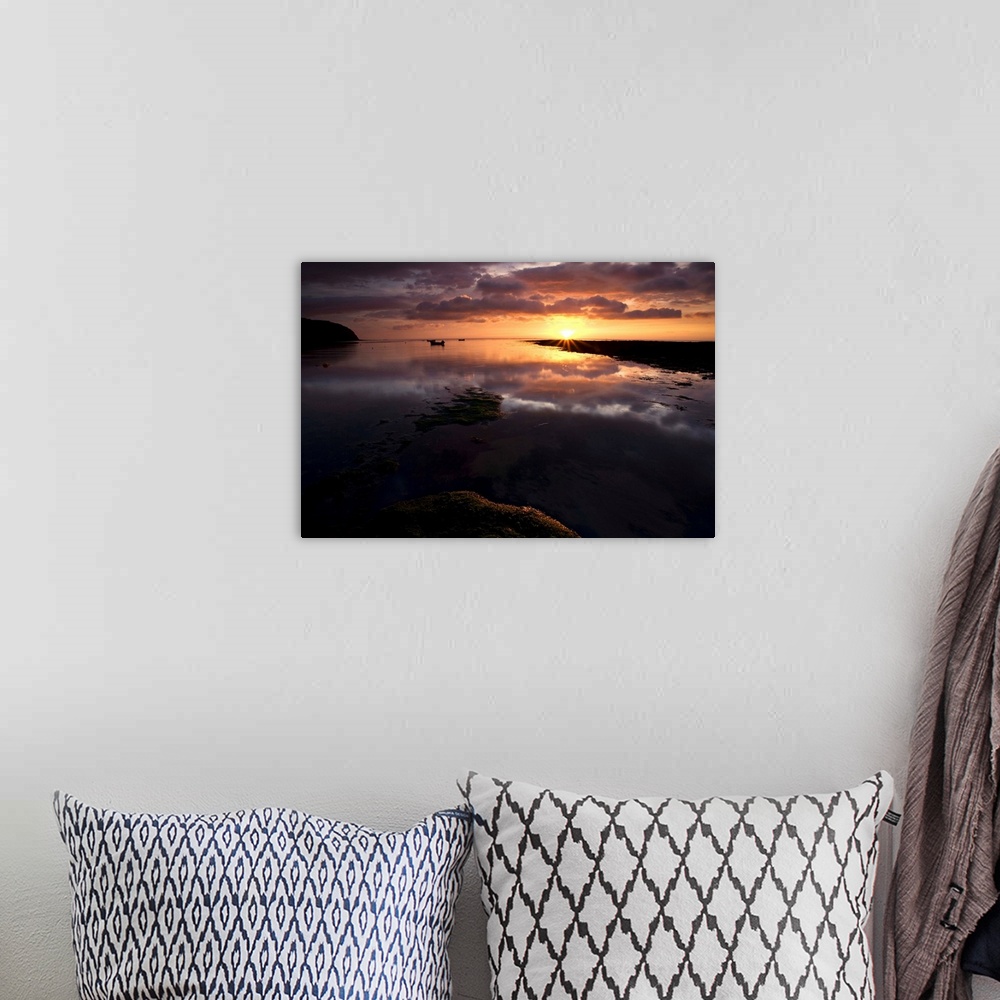 A bohemian room featuring A Beautiful warm golden sunrise over reflecting wet sand with dramatic clouds.