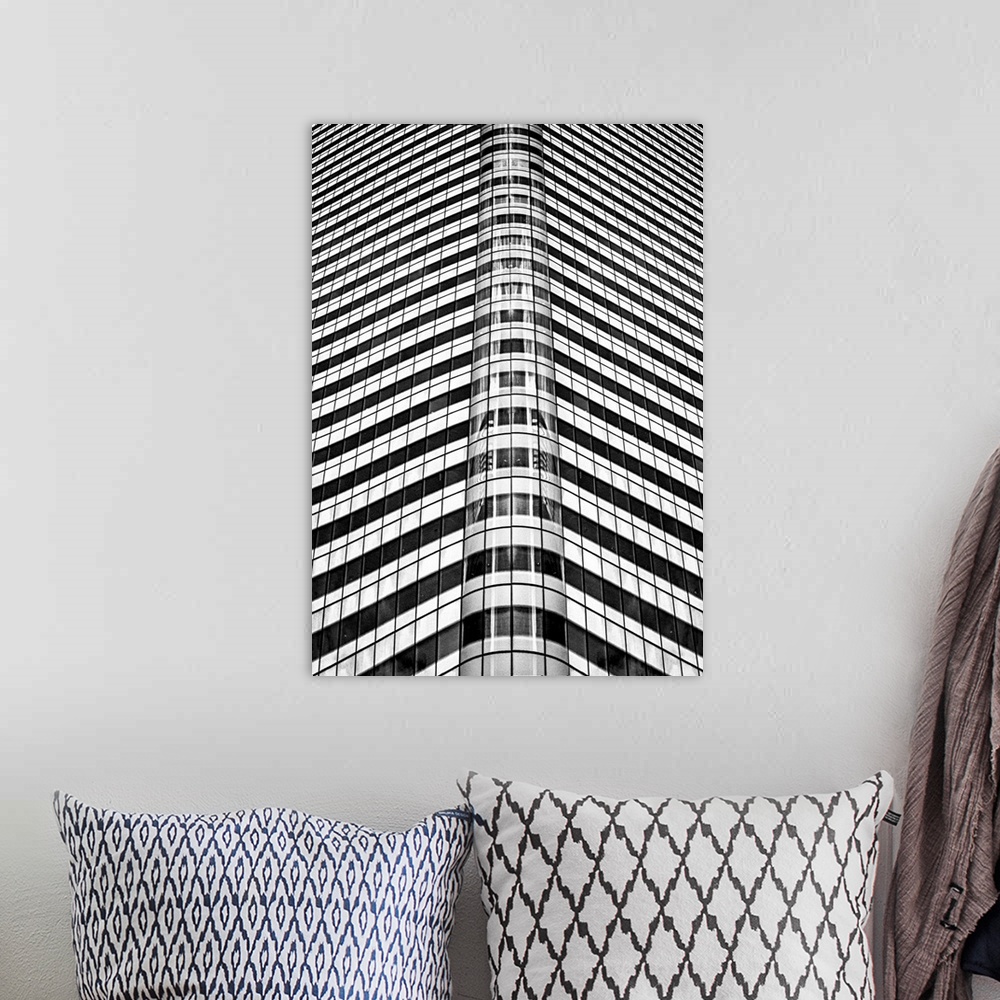 A bohemian room featuring A black and white photograph of an abstract view of a skyscraper.