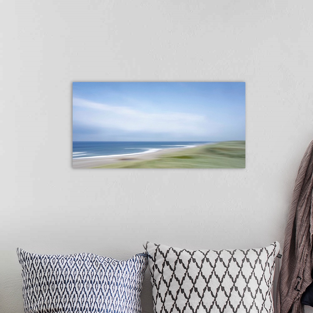 A bohemian room featuring Artistically blurred photo. Strong winds from the sea climb restlessly over the dunes.