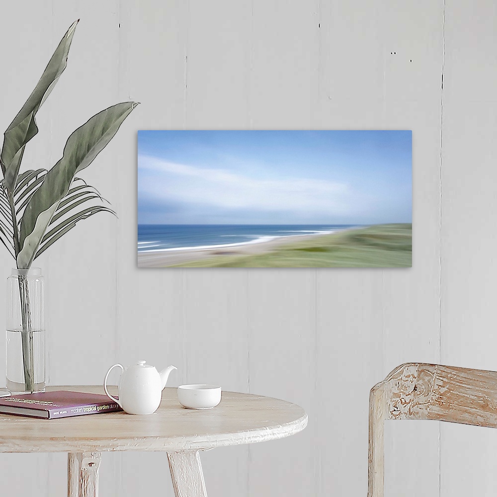 A farmhouse room featuring Artistically blurred photo. Strong winds from the sea climb restlessly over the dunes.