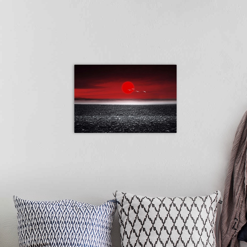 A bohemian room featuring Red sunset over a black sand beach