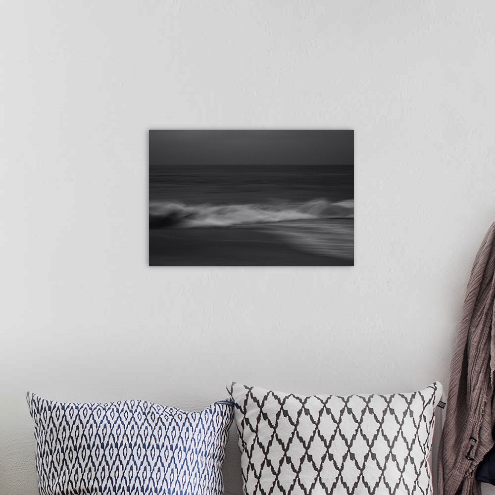 A bohemian room featuring Artistically blurred photo. A calm sea. Waves rise from the undertow and break on the beach.