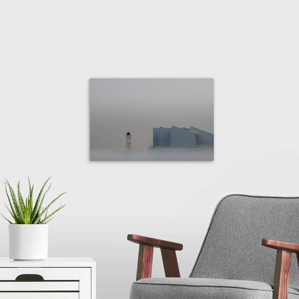 A modern room featuring Fine art photograph of a repeated city building on a gray sky with mist at the bottom rising up.