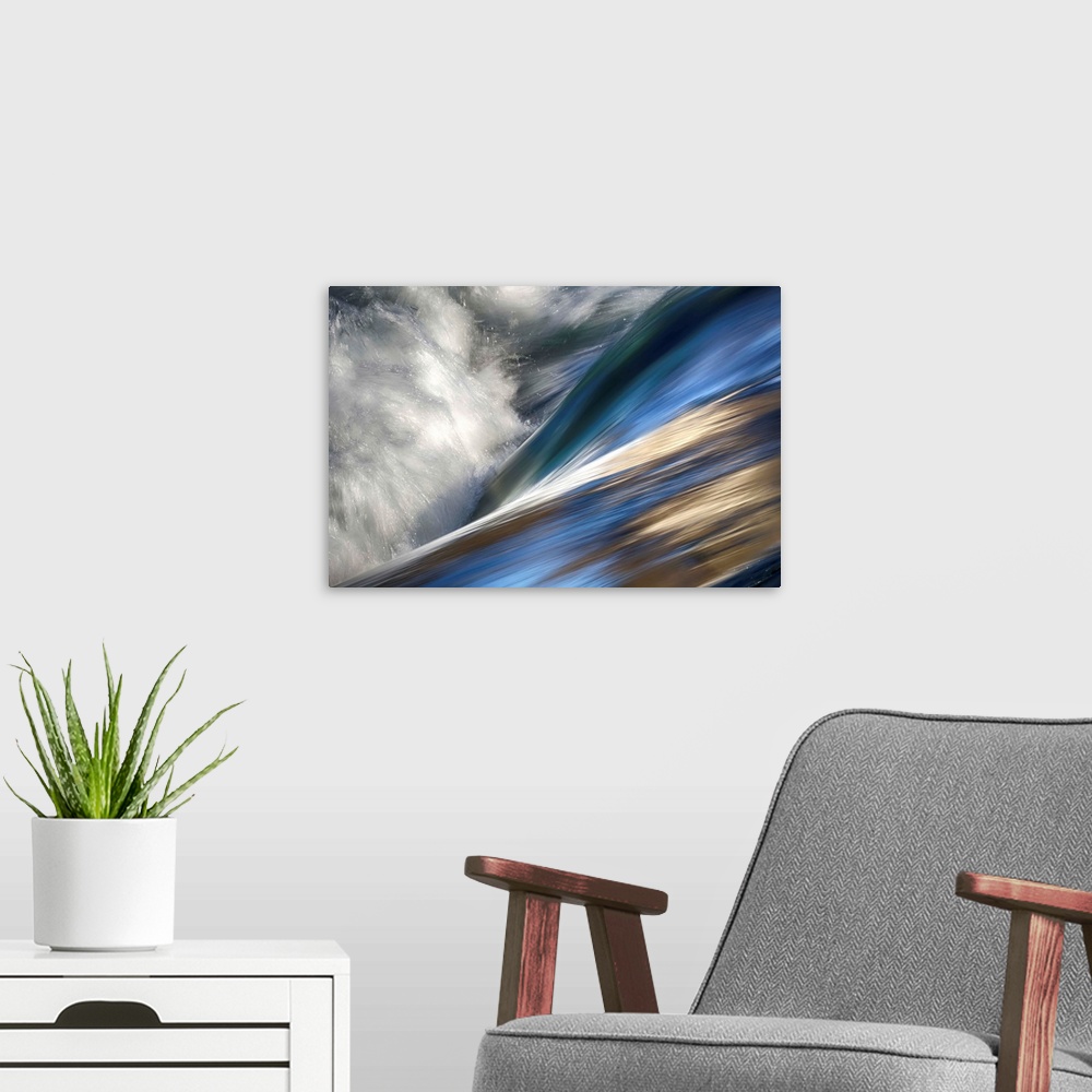 A modern room featuring Abstract photo of rushing water with color reflecting off the waves.