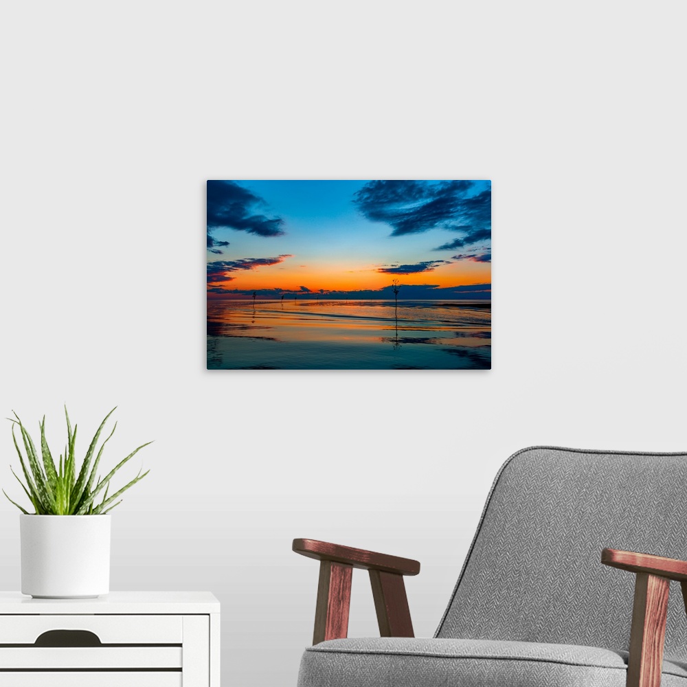 A modern room featuring Boats on calm waters under a colorful sunset in shades of orange and blue.