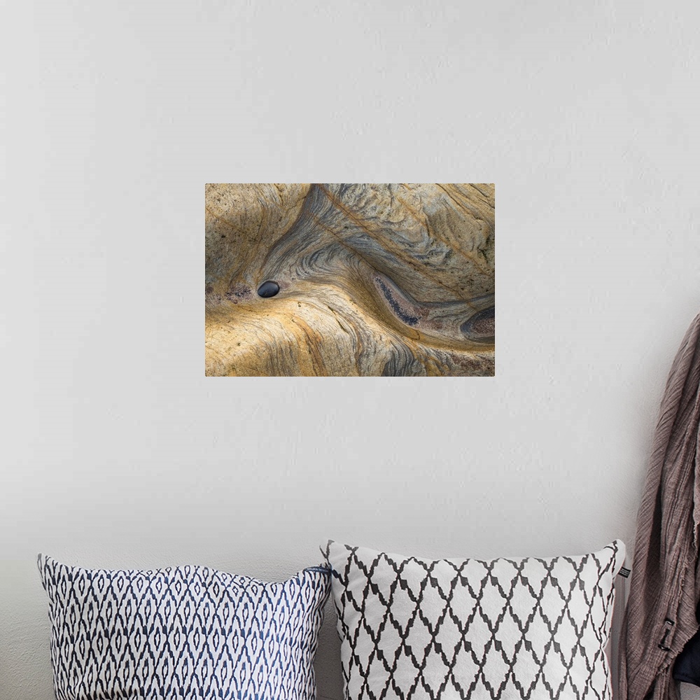 A bohemian room featuring Abstract photograph of a rocky surface displaying all its layers of age and experience.
