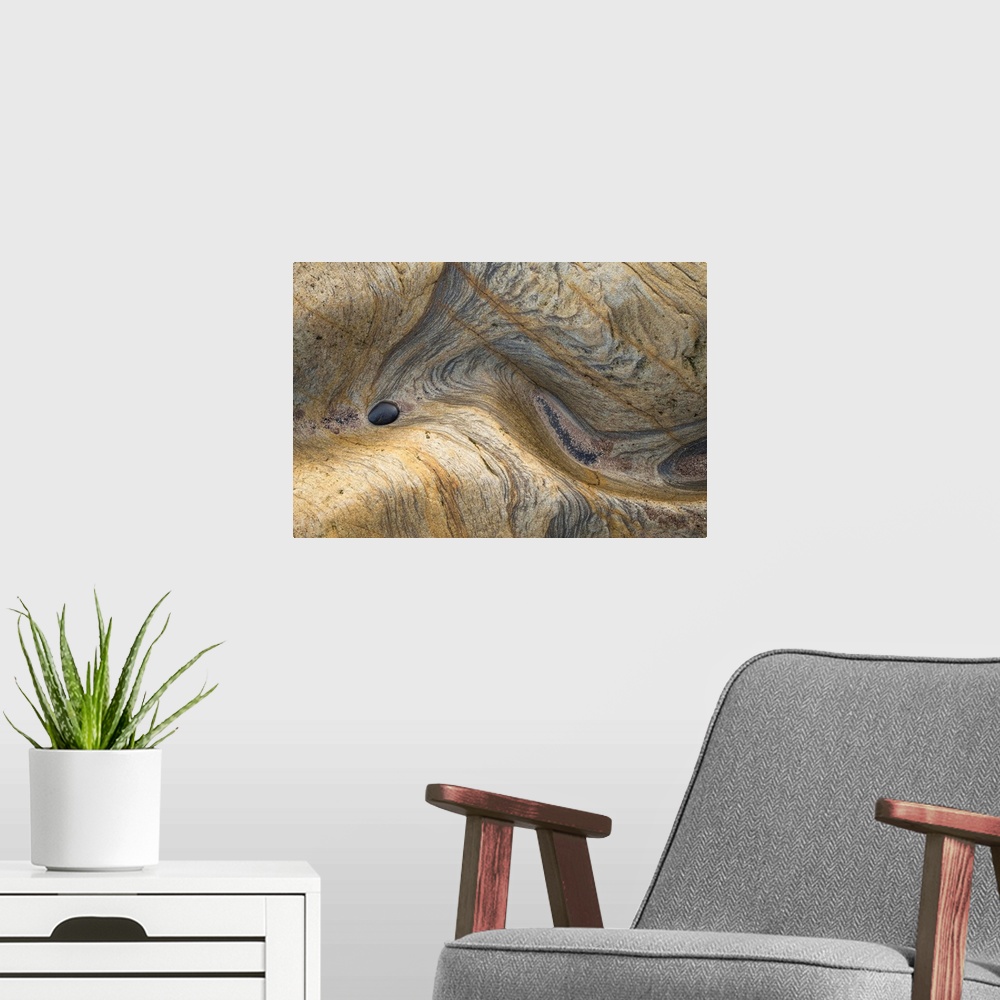 A modern room featuring Abstract photograph of a rocky surface displaying all its layers of age and experience.