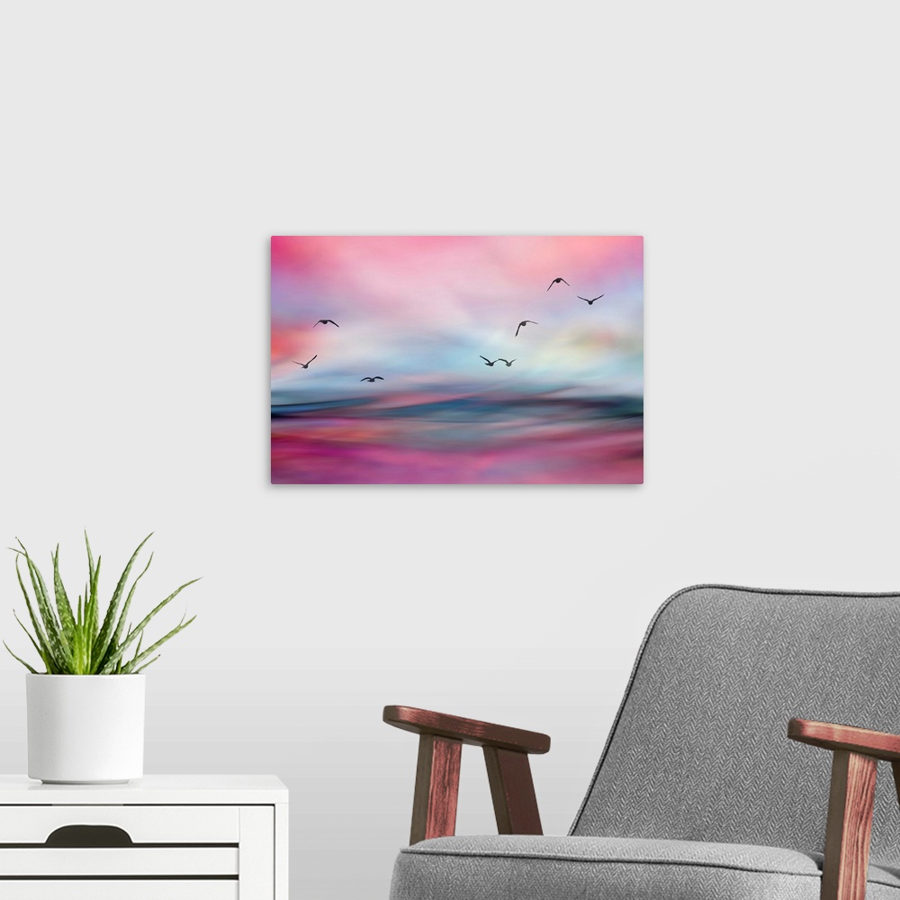 A modern room featuring Birds flying over morning water.