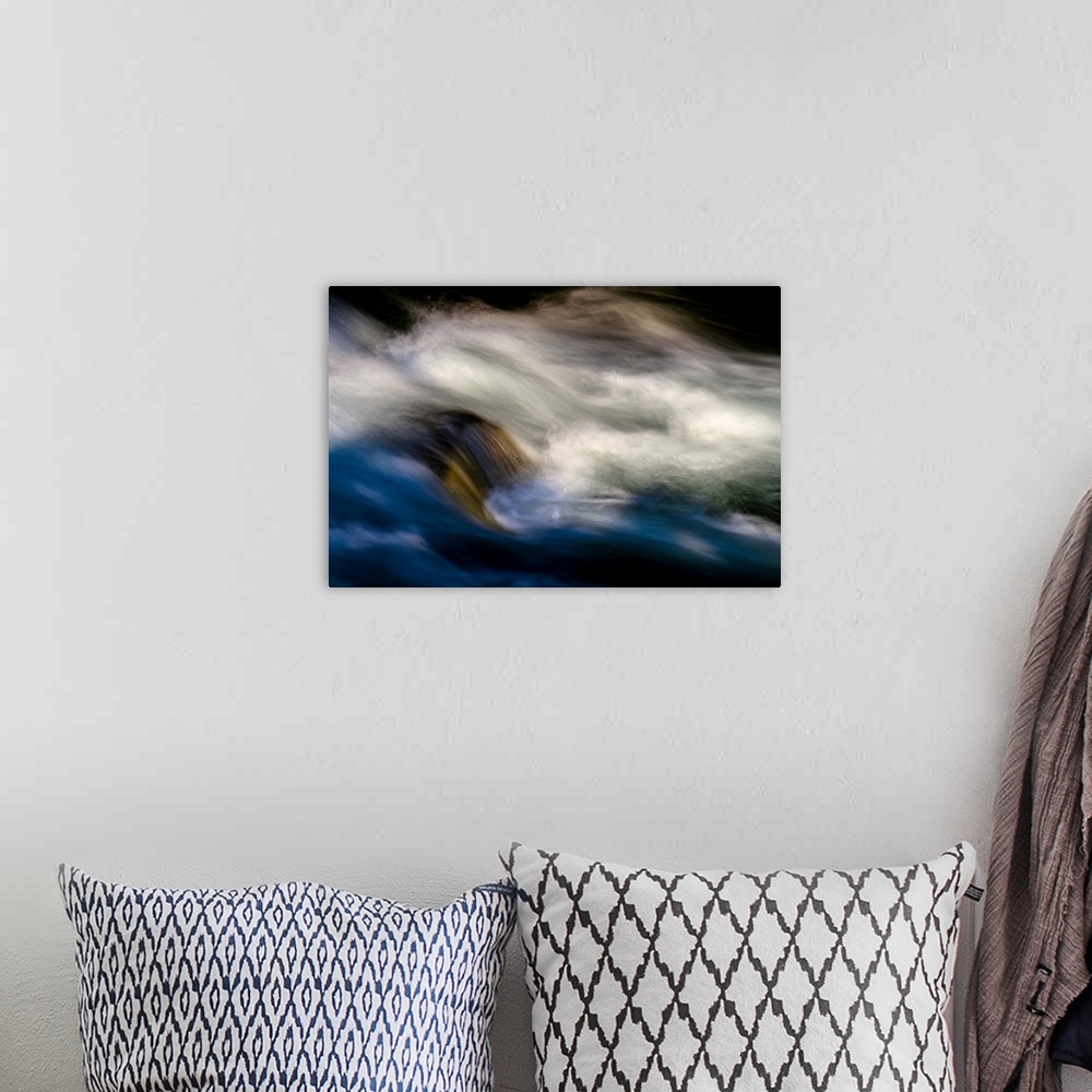 A bohemian room featuring A photo of rushing water with foam that has been edited to a smooth effect.