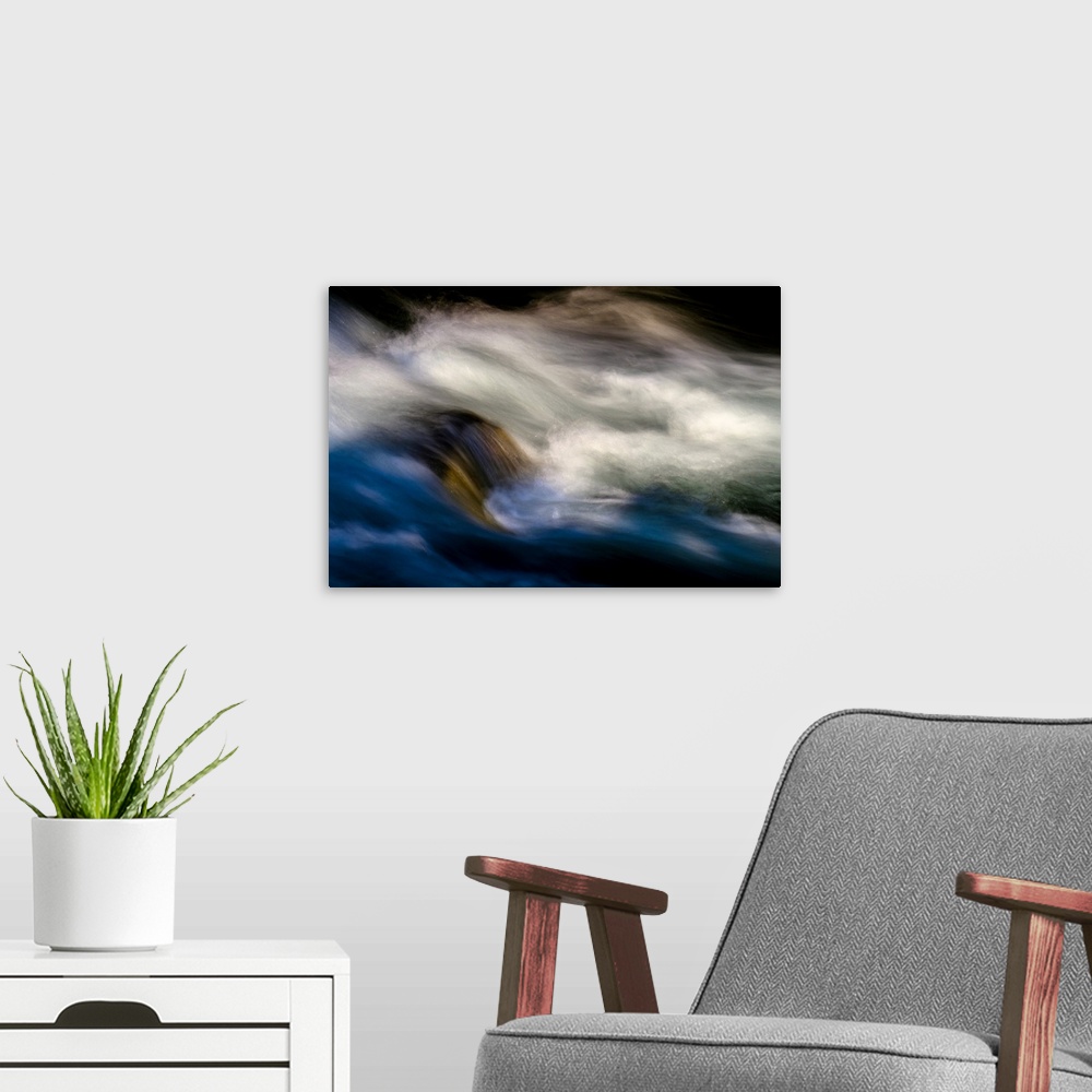A modern room featuring A photo of rushing water with foam that has been edited to a smooth effect.