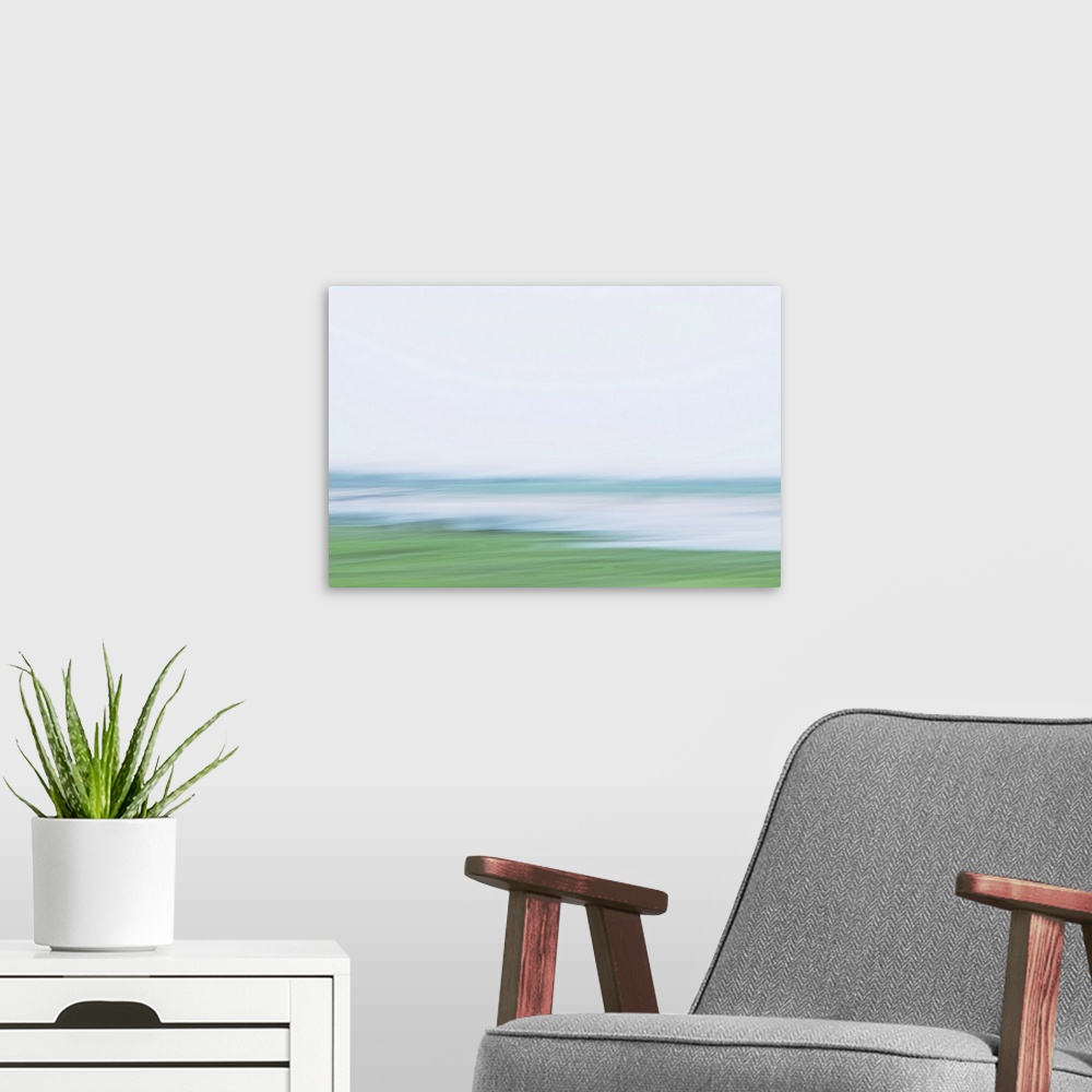 A modern room featuring Artistically blurred photo. A river rushes through the land on its way to the sea.