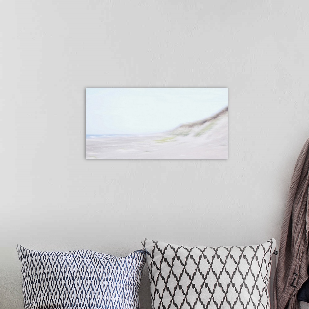 A bohemian room featuring Artistically blurred photo. Waves come to rest on the beach in the safe embrace of the dunes.