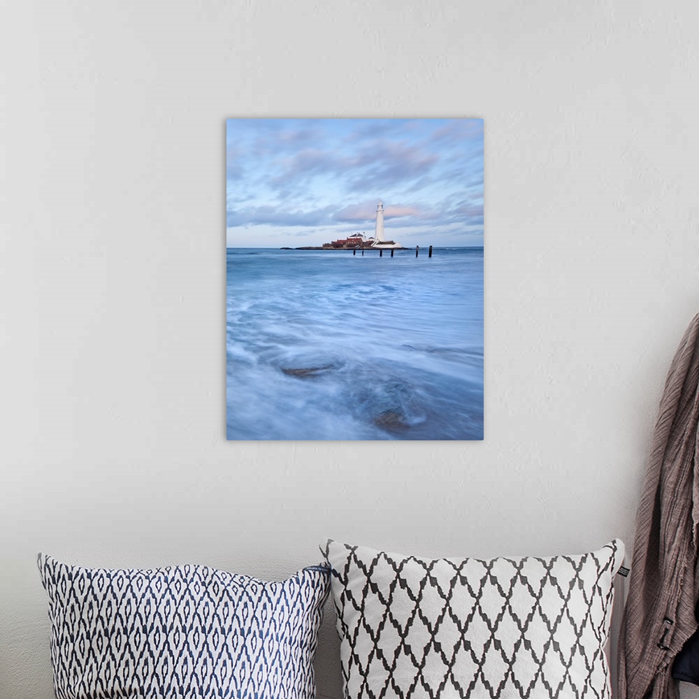 A bohemian room featuring A dramatic image of swirling waves beneath a white Lighthouse and a blue sky at St. Mary's Bay, N...