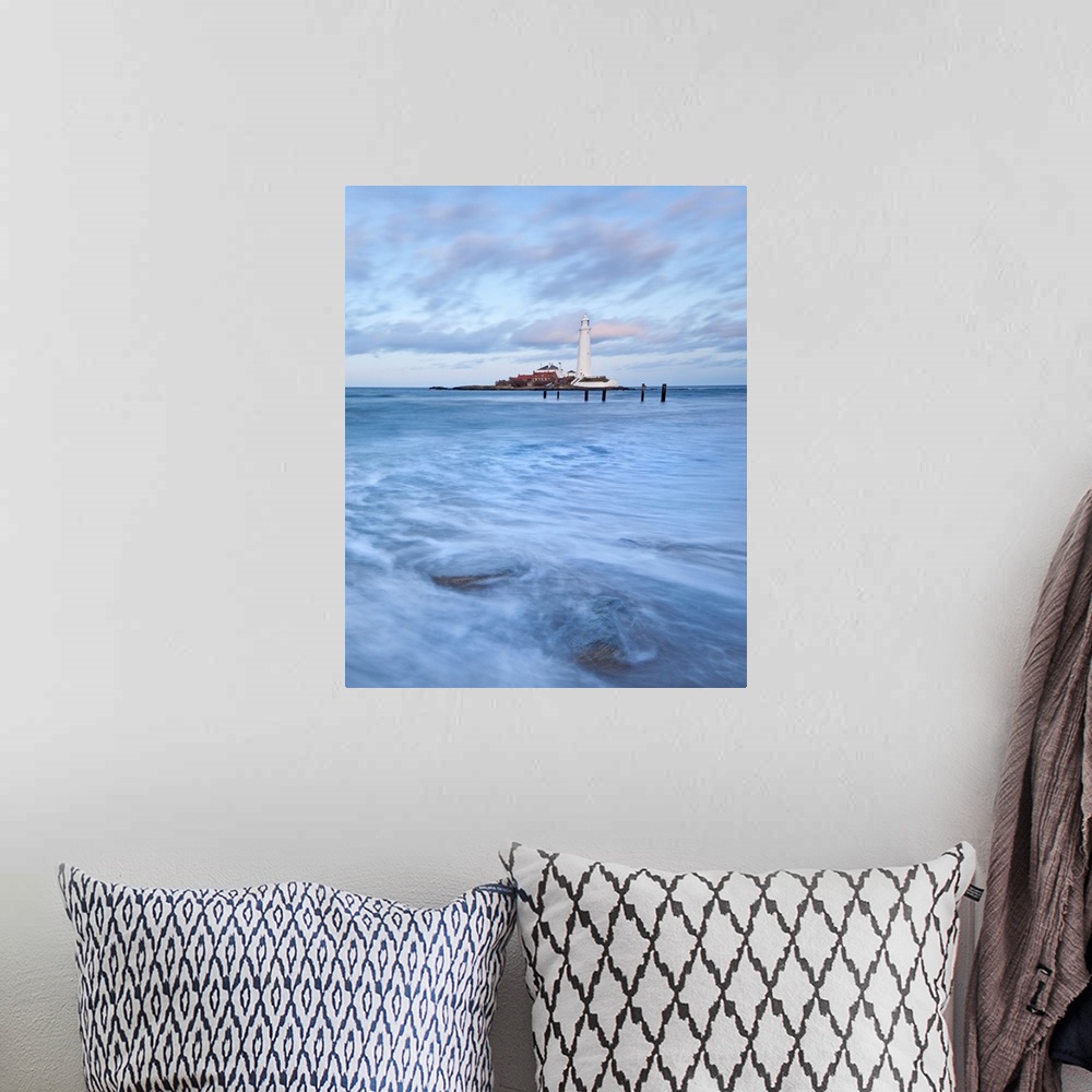 A bohemian room featuring A dramatic image of swirling waves beneath a white Lighthouse and a blue sky at St. Mary's Bay, N...