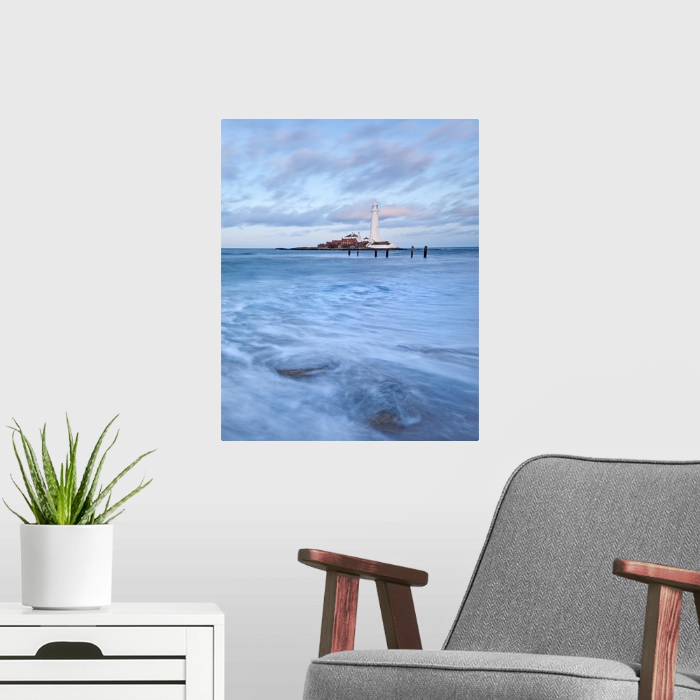 A modern room featuring A dramatic image of swirling waves beneath a white Lighthouse and a blue sky at St. Mary's Bay, N...