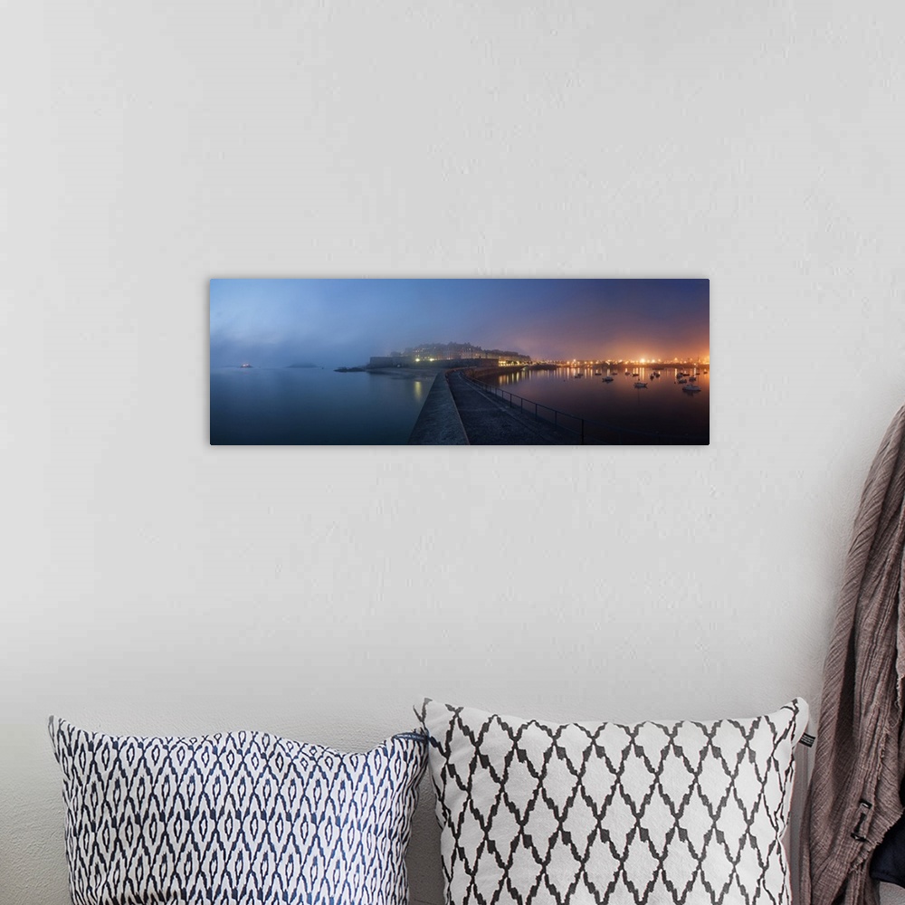 A bohemian room featuring Panoramic view of Saint Malo city in Brittany at night with fog coming from the sea, blue and pin...