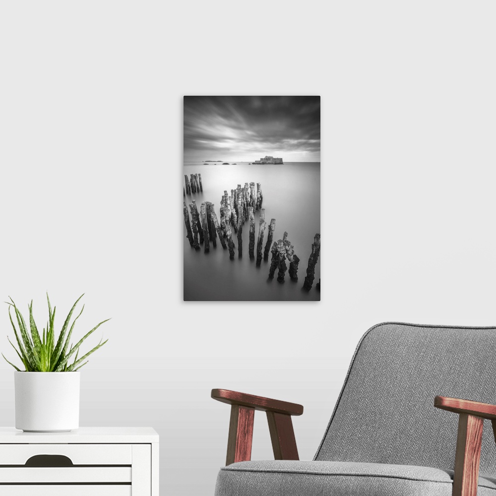 A modern room featuring Black and white vertical long time exposure view of the shorecoast of Saint Malo in Brittany, a v...
