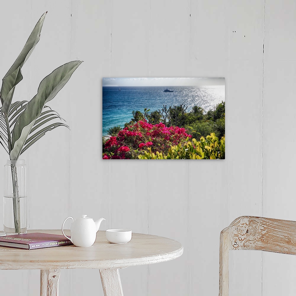 A farmhouse room featuring A photograph of a seascape from a viewpoint with flowers in the foreground.