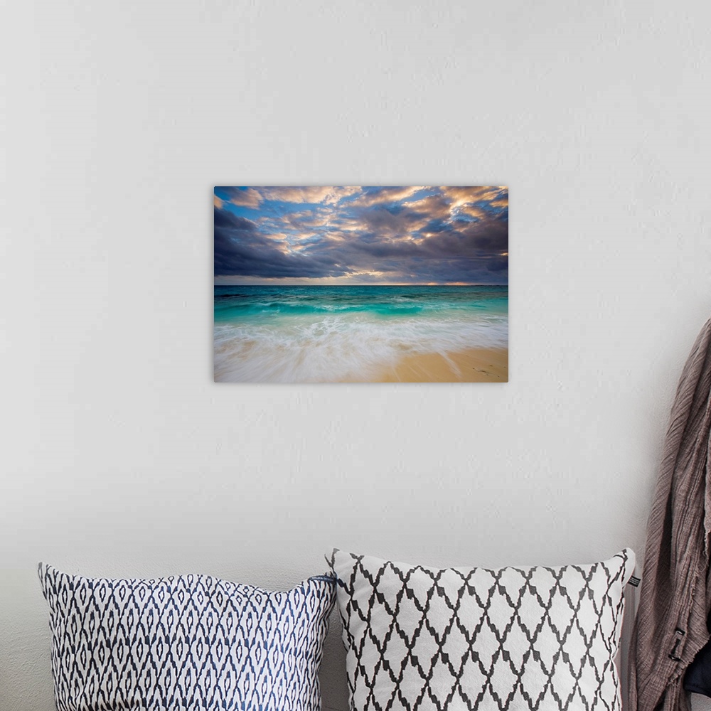 A bohemian room featuring A giant photograph of a beach on the Ambergris Cay Island within the Turks and Caicos Islands.  T...