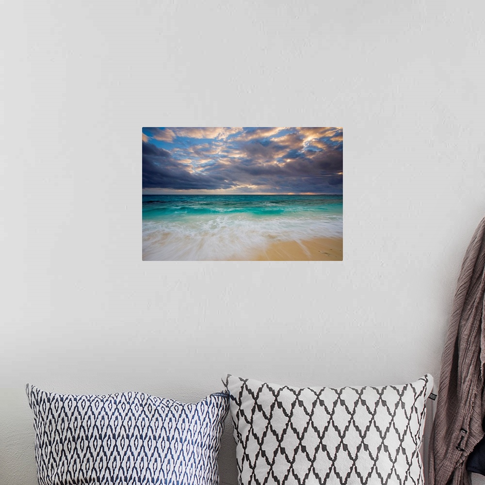 A bohemian room featuring A giant photograph of a beach on the Ambergris Cay Island within the Turks and Caicos Islands.  T...