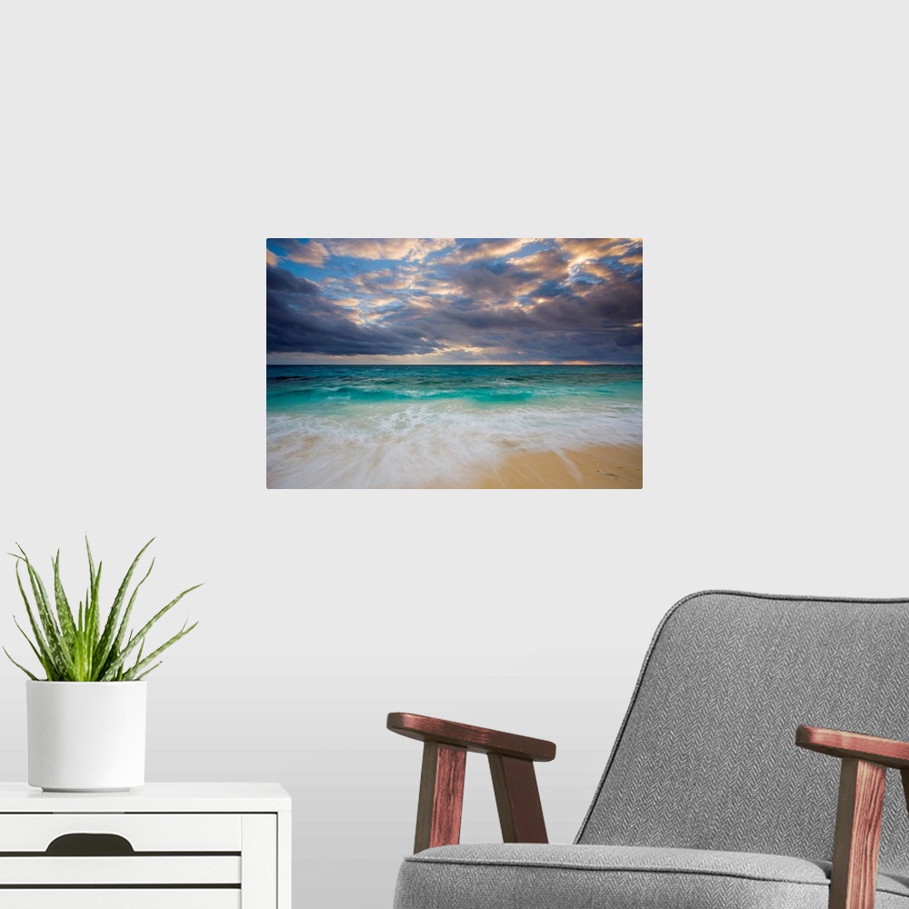 A modern room featuring A giant photograph of a beach on the Ambergris Cay Island within the Turks and Caicos Islands.  T...