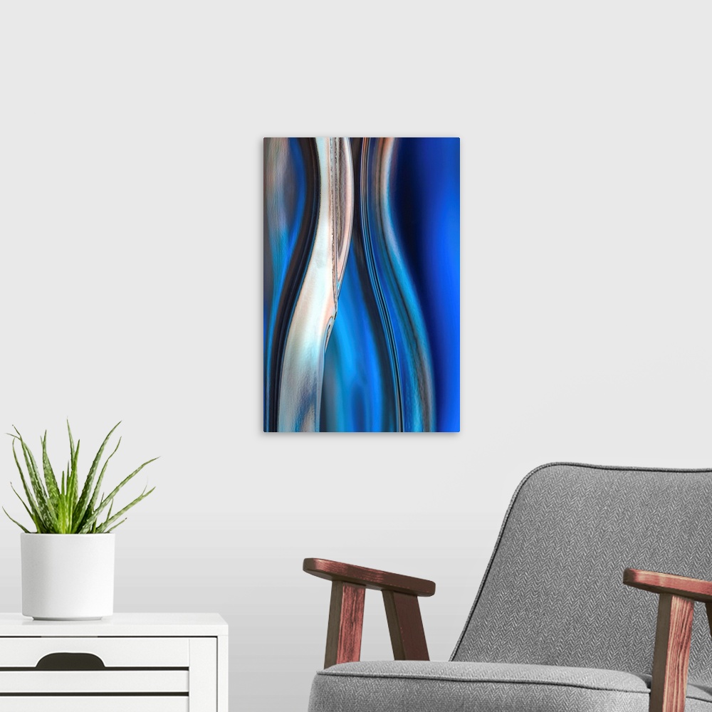 A modern room featuring Contemporary abstract photograph of curved linear lines in shades of blue.