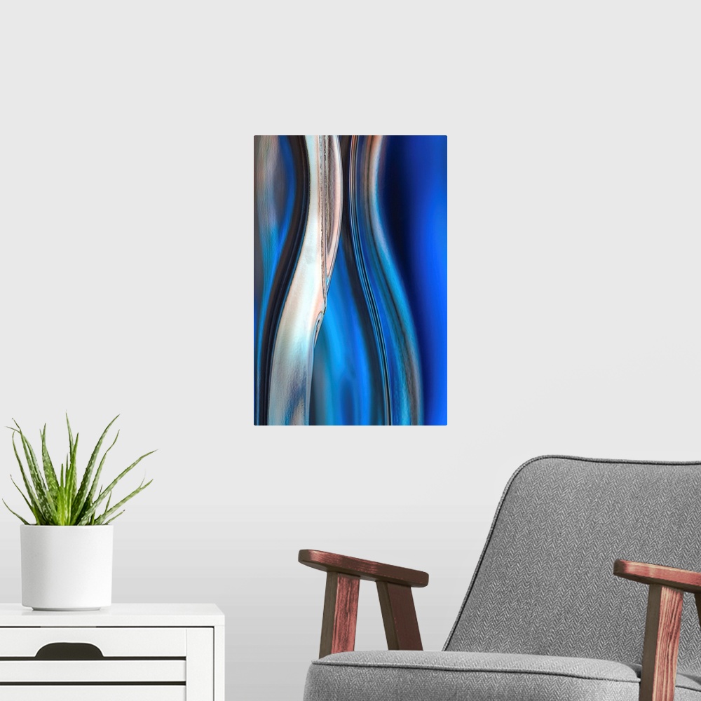 A modern room featuring Contemporary abstract photograph of curved linear lines in shades of blue.