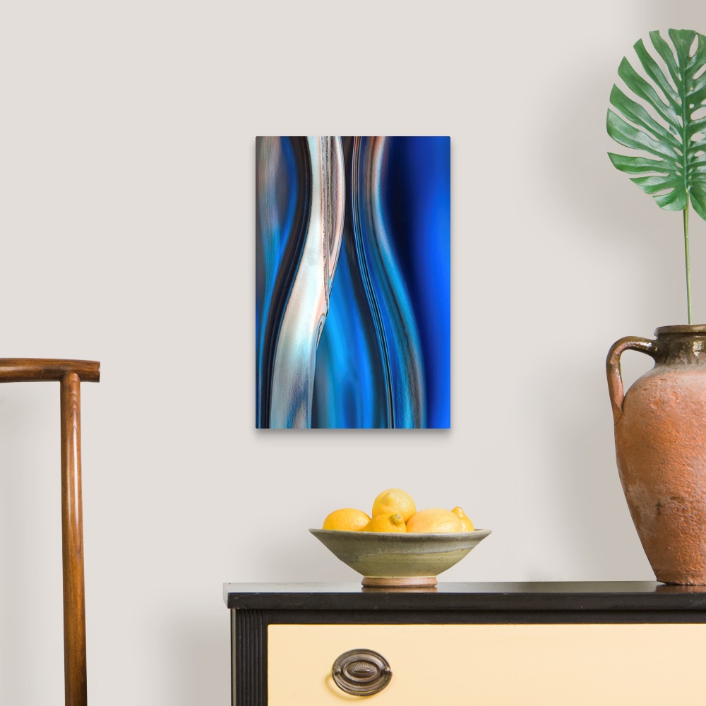 A traditional room featuring Contemporary abstract photograph of curved linear lines in shades of blue.