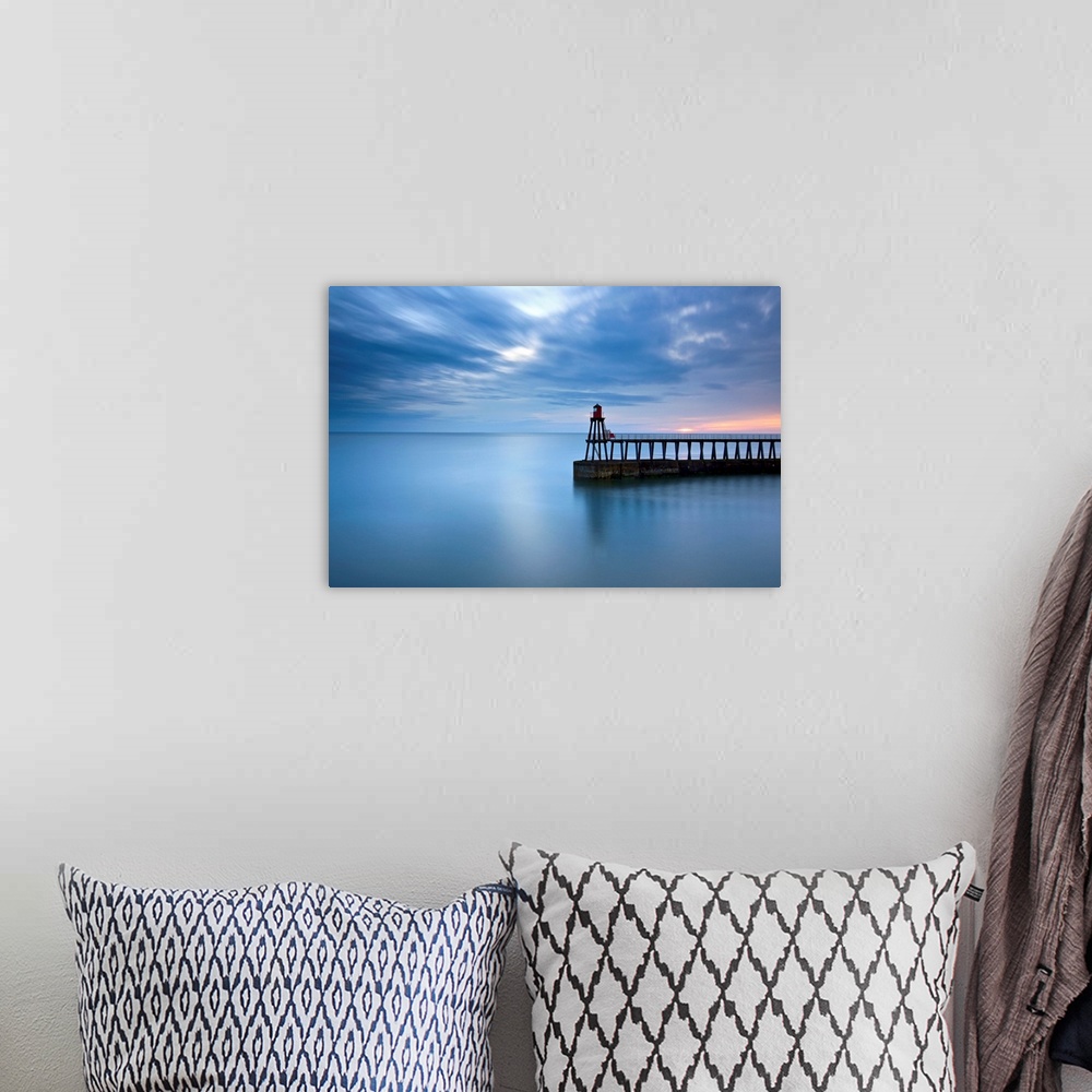 A bohemian room featuring Timeless blue dawn over flat sea with scudding clouds and a lighthouse jetty.