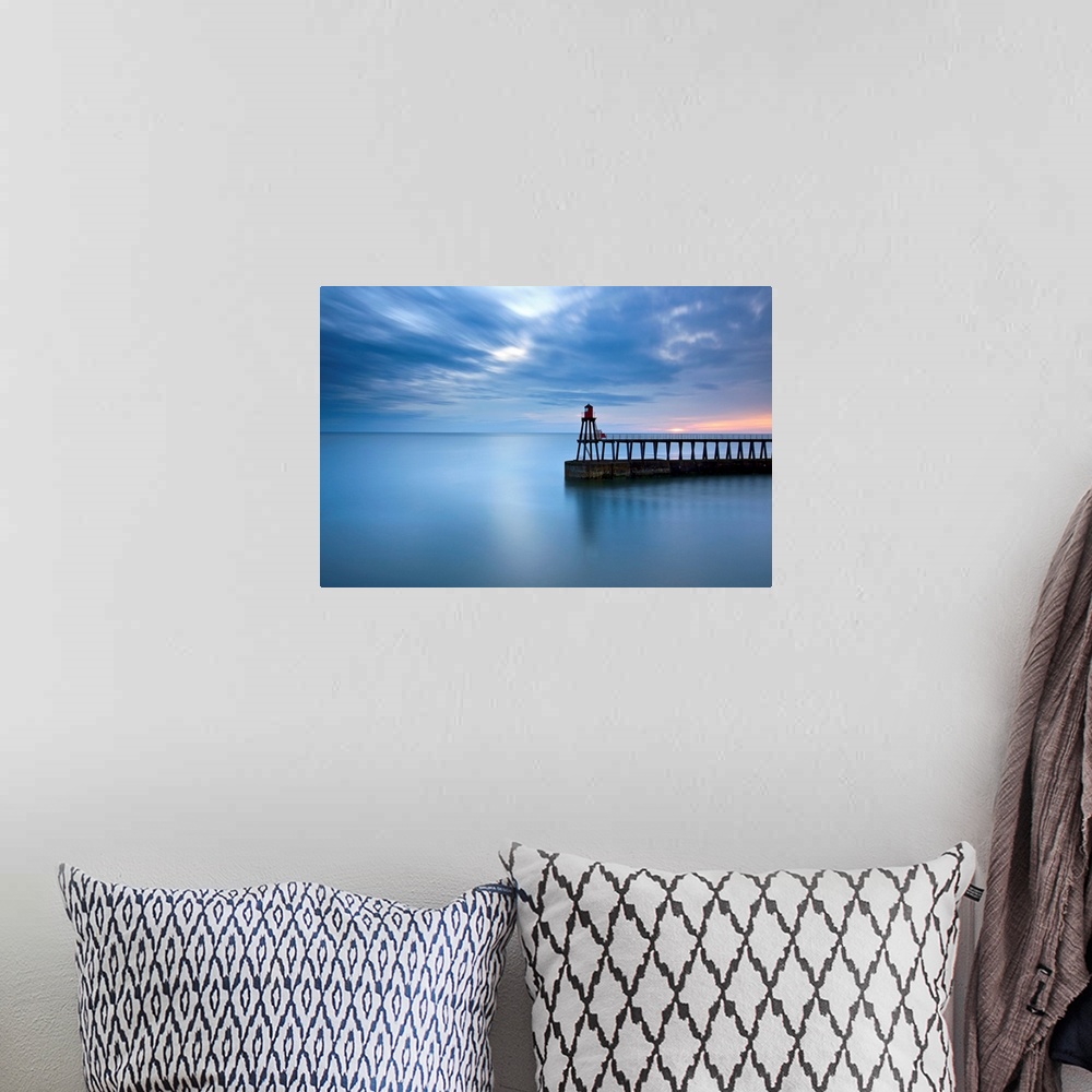 A bohemian room featuring Timeless blue dawn over flat sea with scudding clouds and a lighthouse jetty.