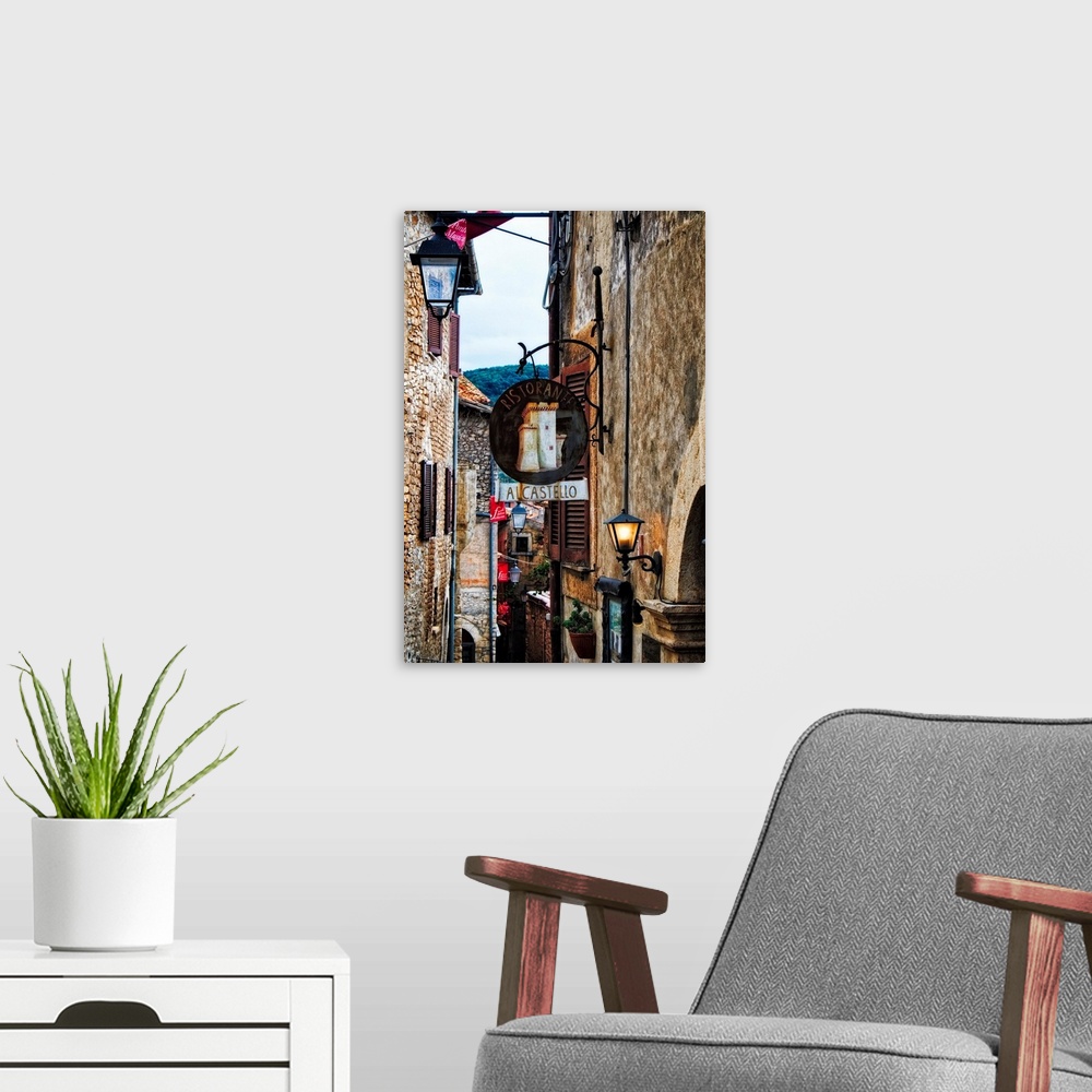 A modern room featuring Narrow Medieval street with signs and lamps, Sermoneta,Latina,  Italy.