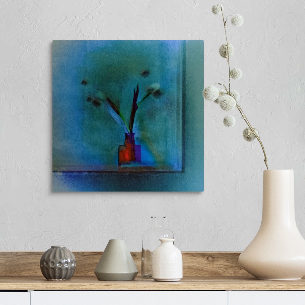 A farmhouse room featuring Square image of a bright red vase with long stemmed tulips on a blue background.