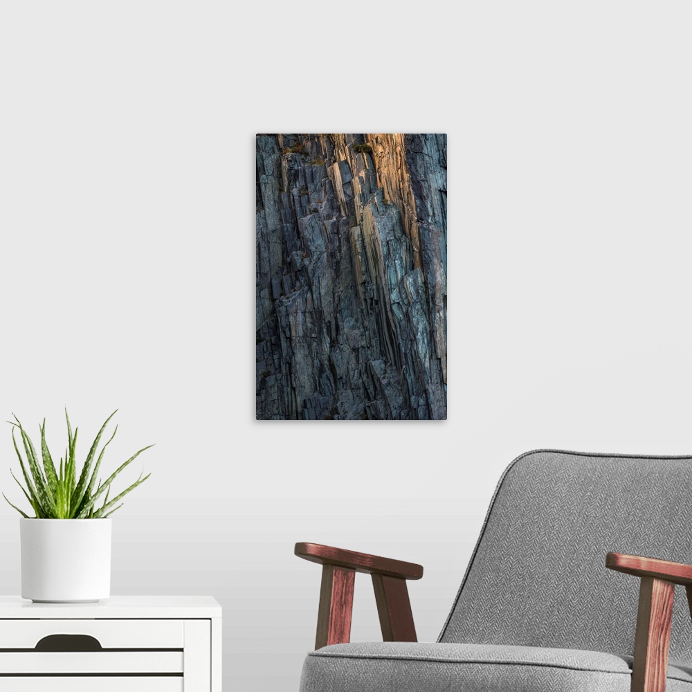 A modern room featuring Fine art photo of a very steep cliff face, with a little glow on the rocks.