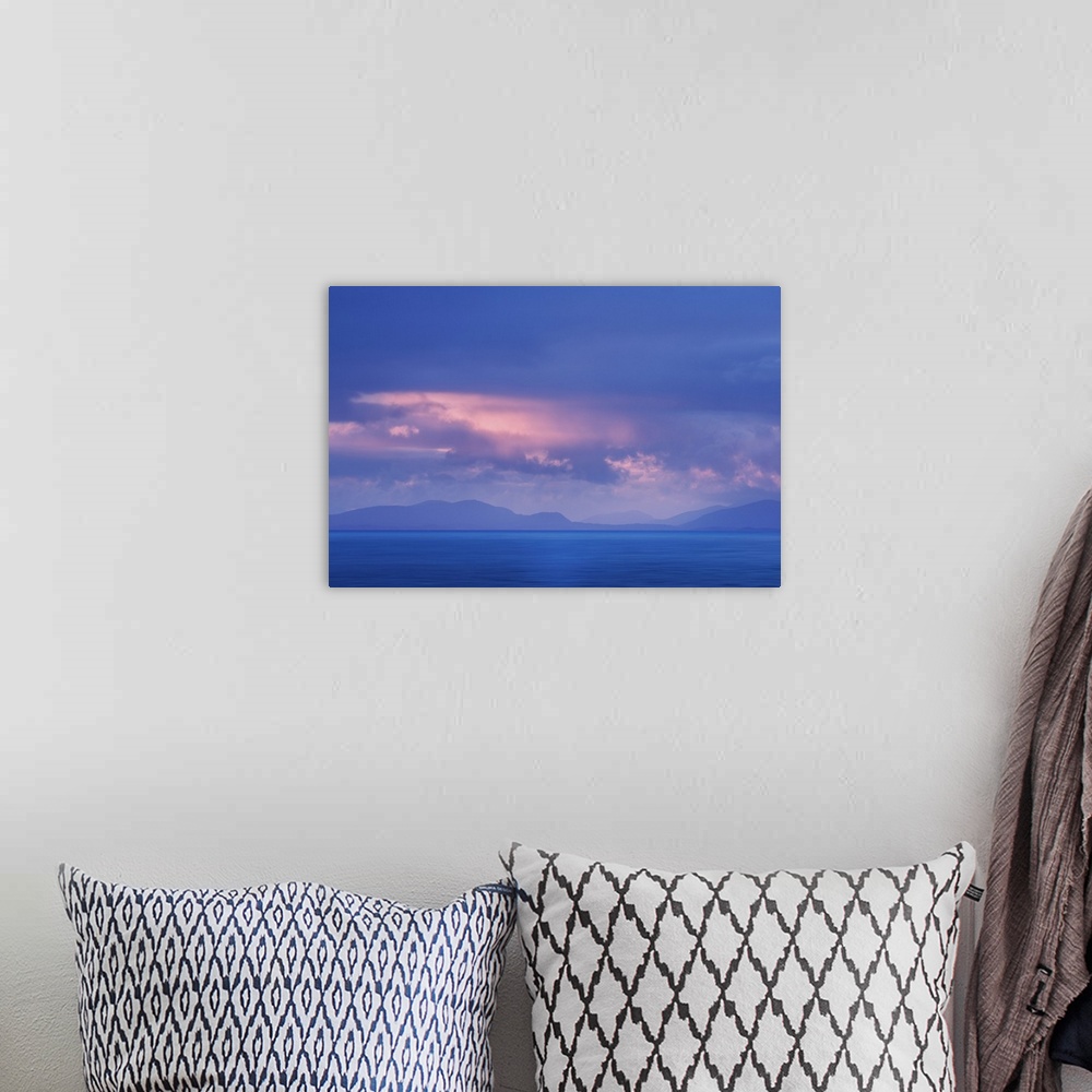 A bohemian room featuring Fine art photo of a misty ocean view with pale clouds above and faint mountains in the distance.