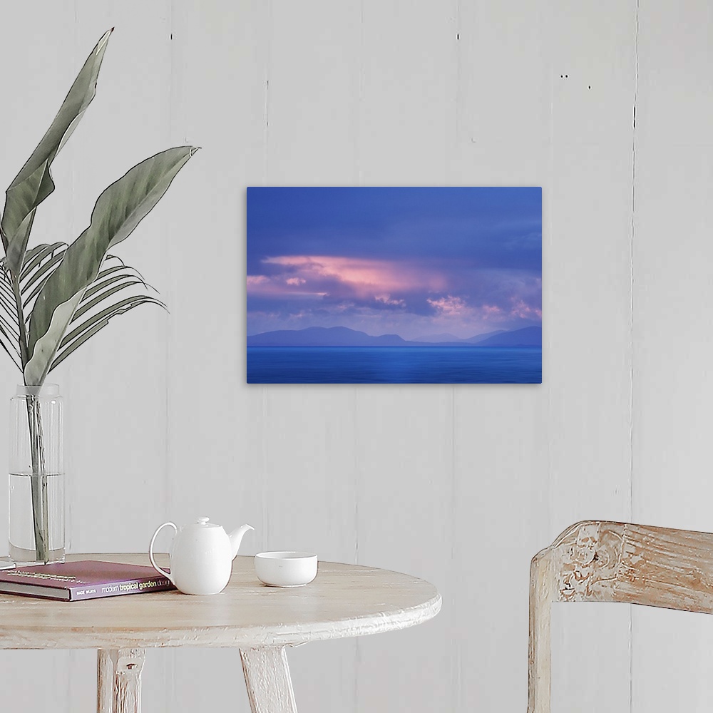 A farmhouse room featuring Fine art photo of a misty ocean view with pale clouds above and faint mountains in the distance.