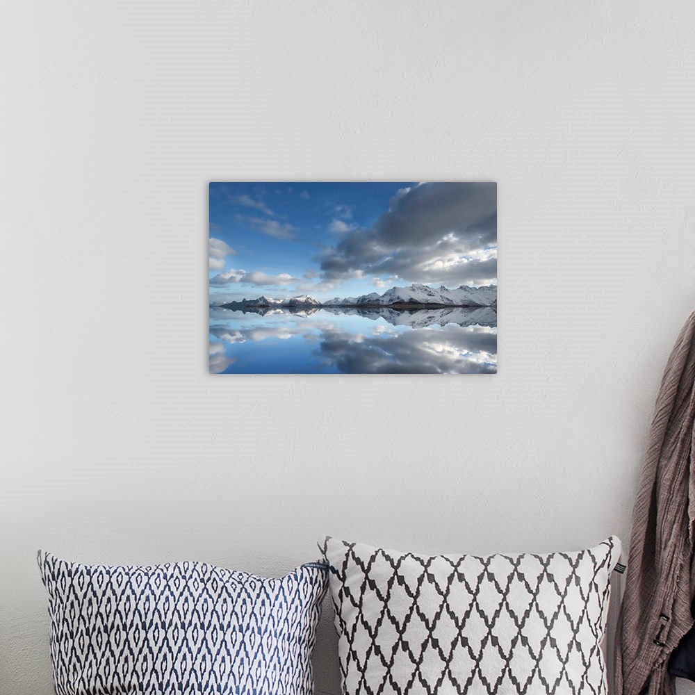 A bohemian room featuring Photograph of a still lake casting a snow covered mountain and cloud reflection.