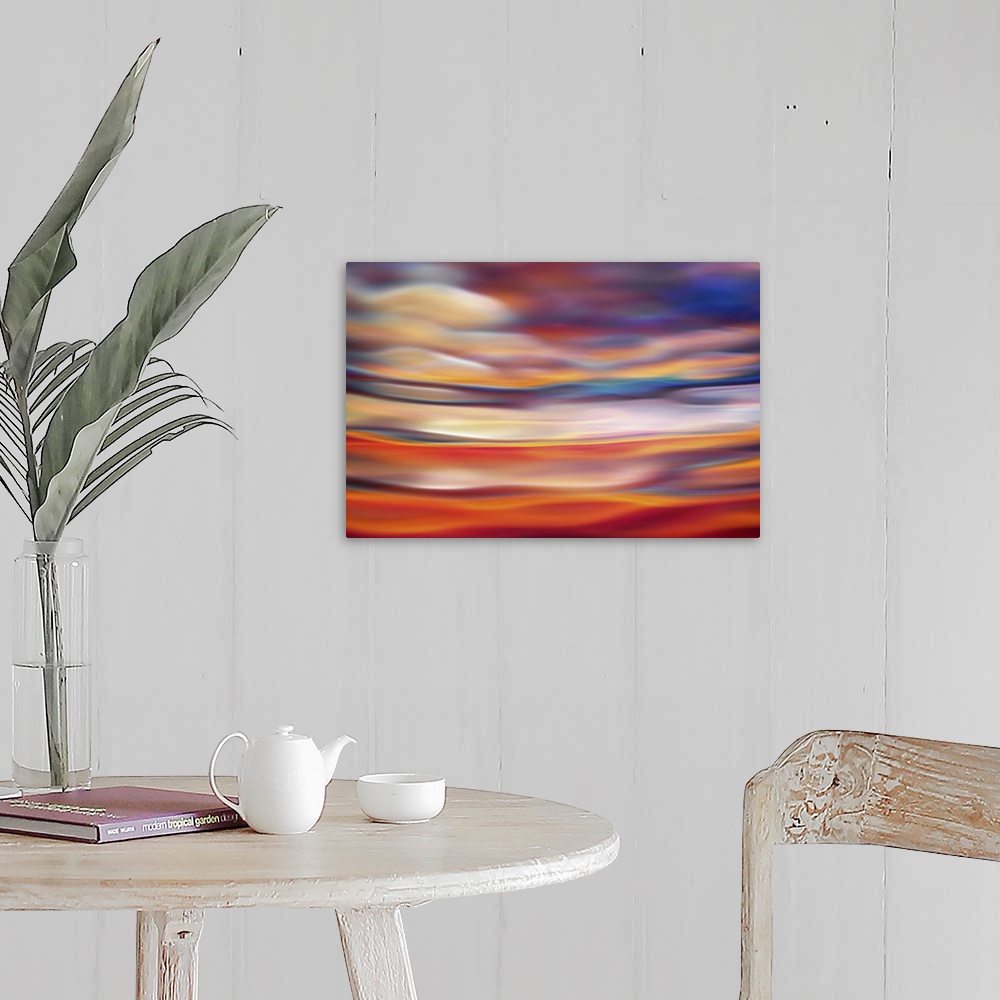 A farmhouse room featuring Abstract photograph in orange and red shades resembling ocean waves.
