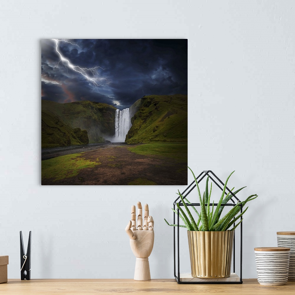 A bohemian room featuring A photograph of lightning striking over a landscape with a waterfall in the distance.
