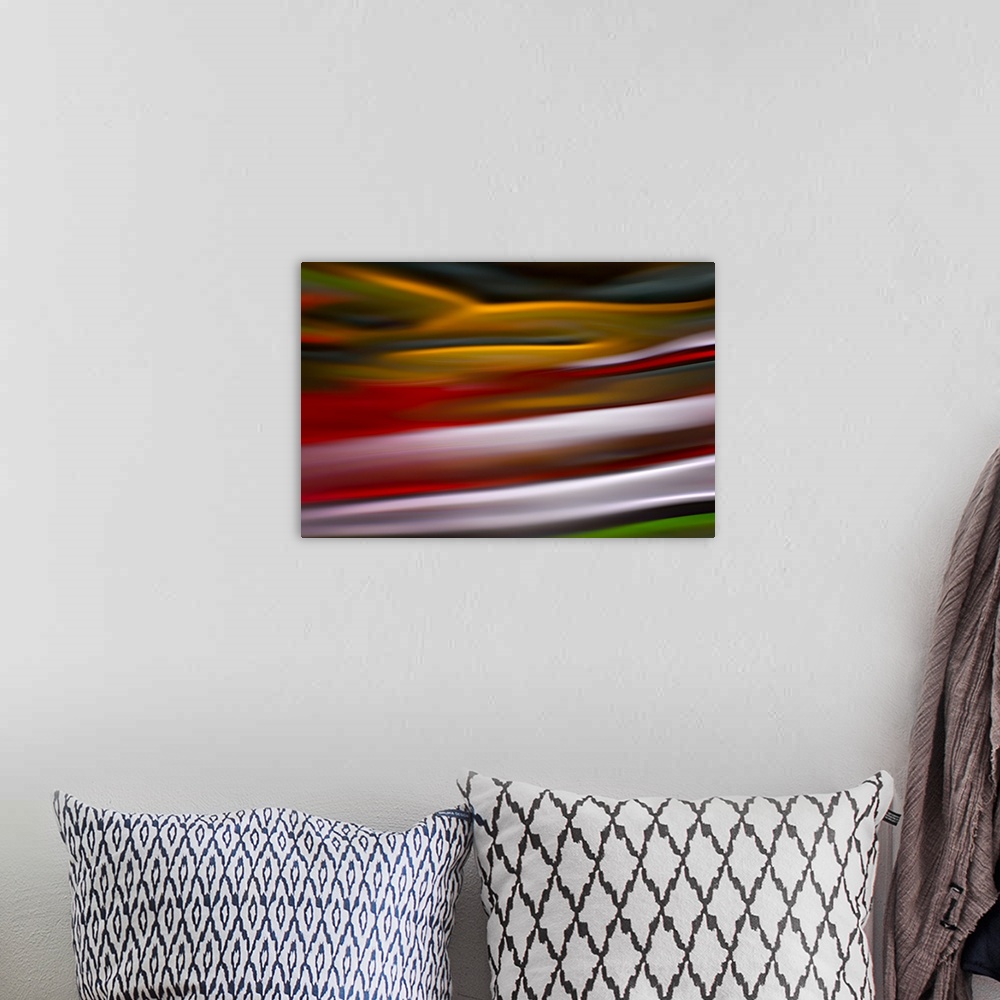 A bohemian room featuring An abstract photograph of vibrant colors in a wave-like formation.