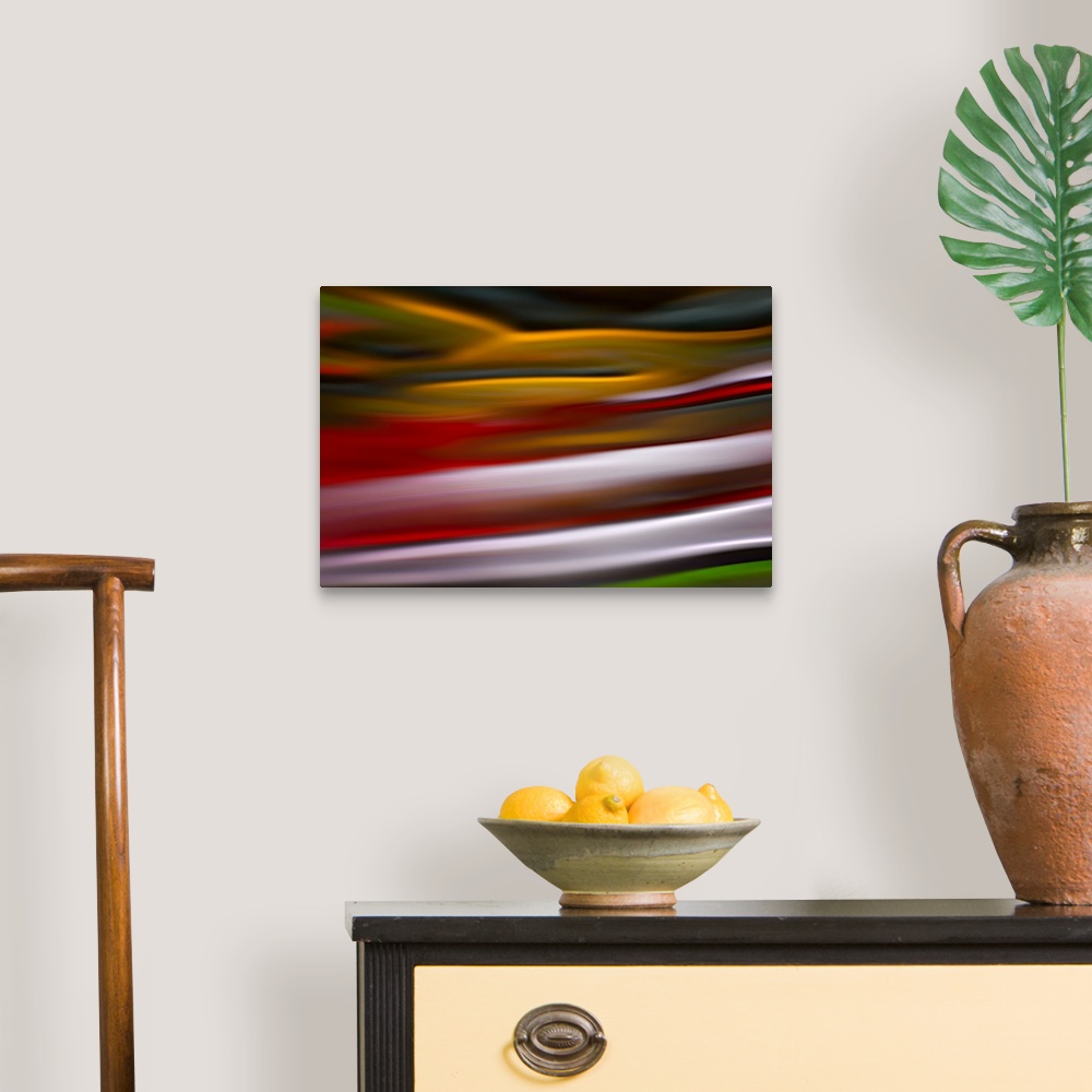 A traditional room featuring An abstract photograph of vibrant colors in a wave-like formation.