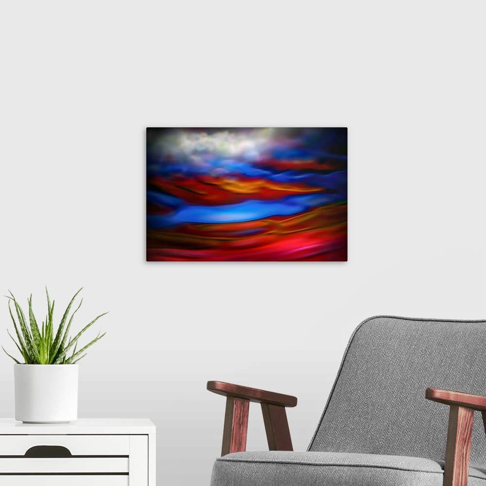 A modern room featuring Abstract photograph in red and blue shades resembling ocean waves.