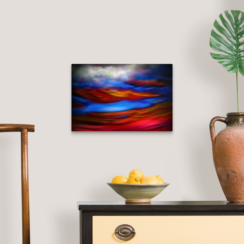 A traditional room featuring Abstract photograph in red and blue shades resembling ocean waves.