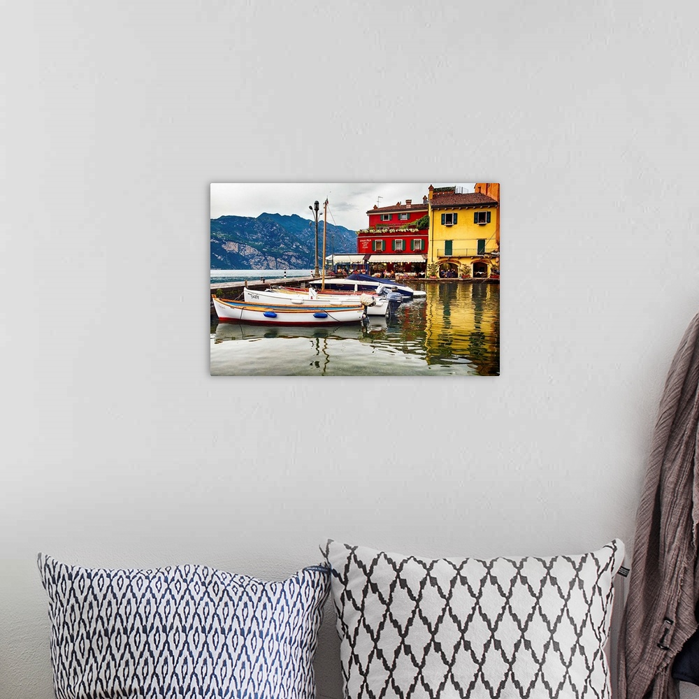 A bohemian room featuring Fine art photo of boats docked in a harbor near brightly painted houses in Italy.