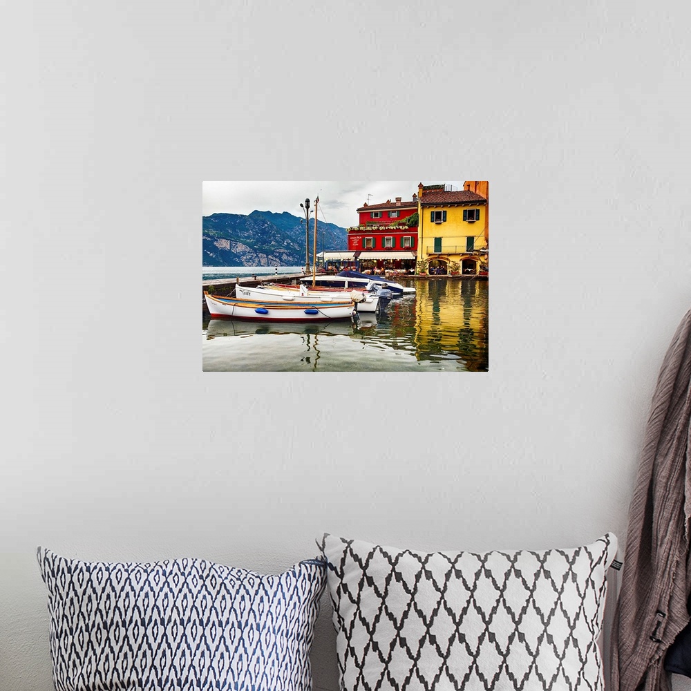 A bohemian room featuring Fine art photo of boats docked in a harbor near brightly painted houses in Italy.